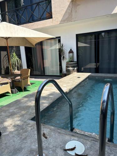 a swimming pool in the middle of a house at D&B apartments in Lo de Marcos