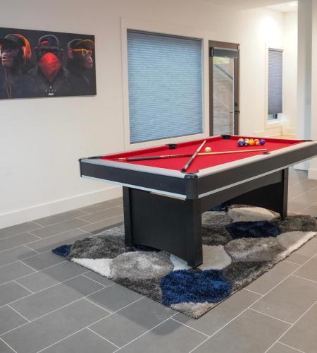 a pool table in a room with a red pool at Stairway To Heaven in Atlanta