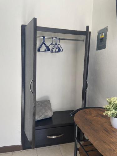 a room with a closet with a table and a mirror at Tlaxcala Apartment # 5 in Ciudad Obregón
