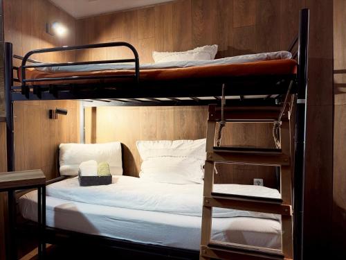 a room with two bunk beds and a desk at Cozy in Sarajevo