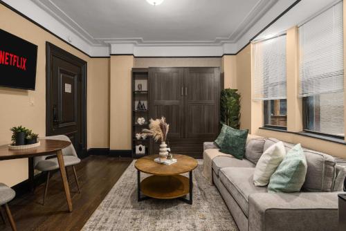 a living room with a couch and a table at Stunning Apt in The Heart of New York City GYM in New York
