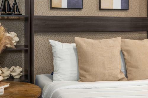 a bedroom with a bed with pillows and a table at Stunning Apt in The Heart of New York City GYM in New York