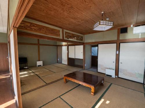 an empty room with a table in the middle of it at HOTEL MtFuji MOMO AUNG 桃庵 in Yamanakako