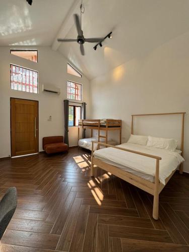 a bedroom with a bed and a ceiling fan at The Rubber Escape, Melaka in Malacca
