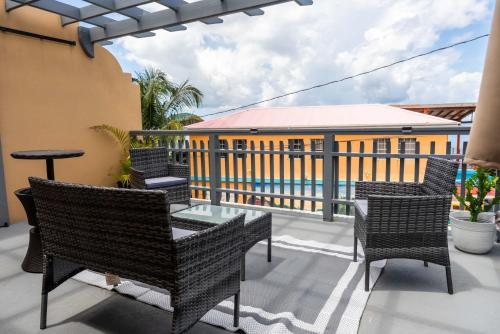 a balcony with chairs and a table and a building at Kurt's Bayside Oasis in Anderson