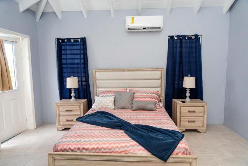 a bedroom with a bed with two night stands and two lamps at Kurt's Bayside Oasis in Anderson