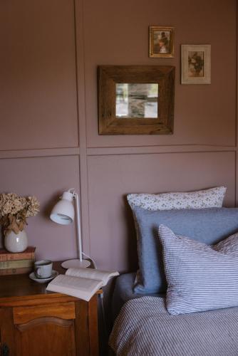 a bedroom with a blue bed and a desk with a lamp at Thagg Haus - Charming Miners Cottage in Wonthaggi in North Wonthaggi