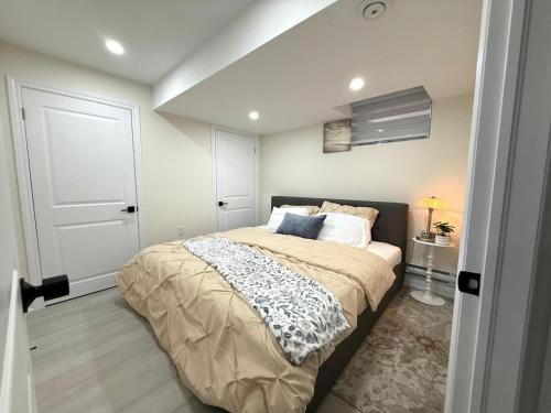 a bedroom with a large bed and a white door at Modern 2BR Suite Private Entrance Parking New in Woodstock