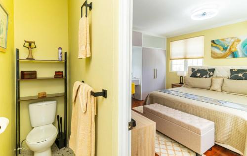 a bathroom with a bed and a toilet in a room at Paradise Haven Saint Lucia in Corinthe