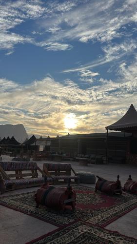 a group of benches sitting on a rug in a courtyard at Sunset mountain in Disah