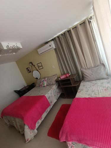a bedroom with two beds and a window at Villa sonhos in Belém