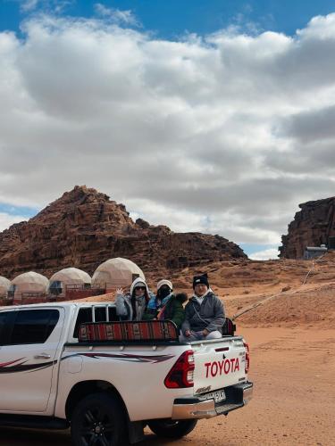 a group of people sitting in the back of a truck at Moon view in Disah