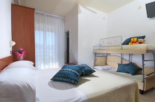 a bedroom with a bed and a bunk bed at Hotel caesar in Cattolica