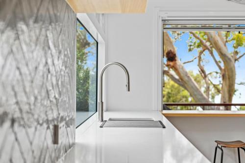 a kitchen with a sink and a window at Surf Gums, Sleeps 9, Pet Friendly, Fully Renovated in Point Lookout