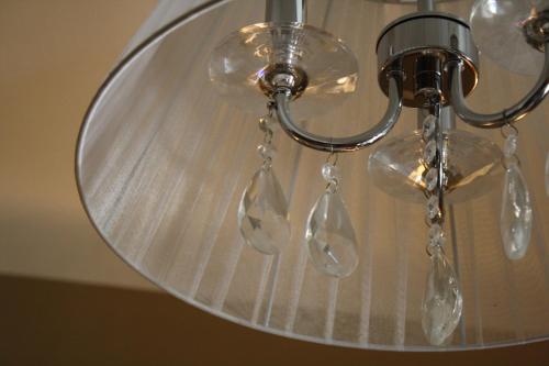 a glass ceiling light with four clear glass bulbs at Hotel Nuovo Nord in Genova
