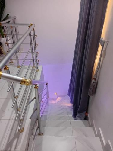 a stairway with purple lights in a room at Olori apartments in Adeleye