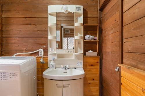a bathroom with a sink and a washing machine at 那須ウッドペッカーBBQ & Petりんどう湖近くの一棟貸別荘 in Nasu