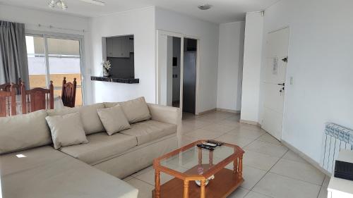 a living room with a couch and a table at Torre del Lago in Villa Carlos Paz