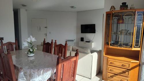 a dining room with a table and a cabinet at Torre del Lago in Villa Carlos Paz