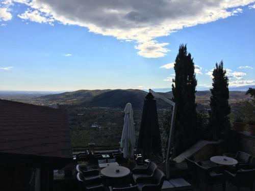 a view of a patio with umbrellas and chairs at Varosi 4 Seasons in Edessa