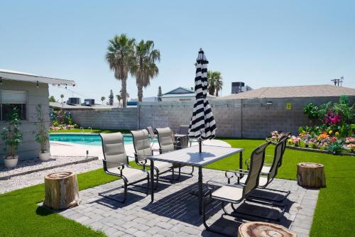 a patio with a table and chairs and a pool at Vegas Hideaway with Jacuzzi & Pool by Strip in Las Vegas