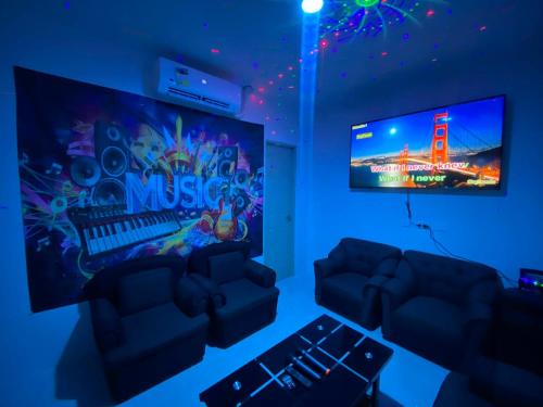 a living room with two couches and a tv at Baywatch Beach Resort in Olongapo
