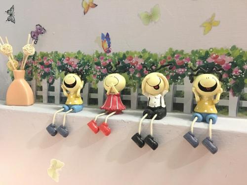 a group of toy figurines sitting on a ledge at 站前海民宿 in Hualien City