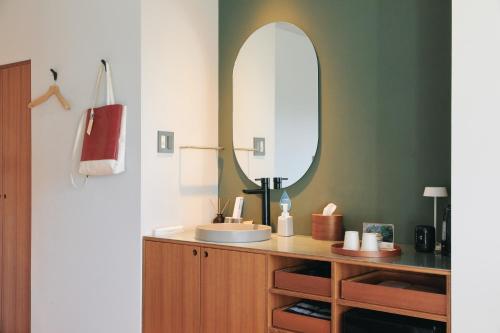 a bathroom with a sink and a mirror at Tiny Garden Tateshina in Chino