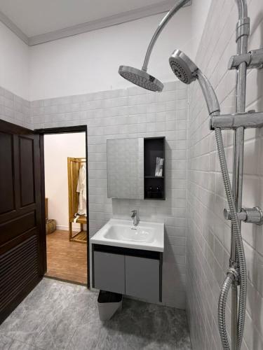 a bathroom with a sink and a shower at Sunin Hotel Dondet Riverside in Don Det
