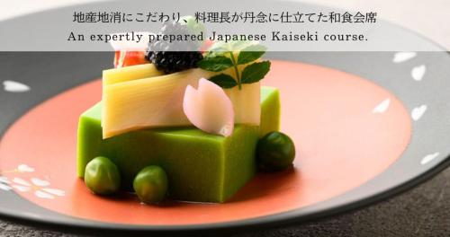 a green dessert with cheese and grapes on a plate at Ubusuna no Sato TOMIMOTO in Ando