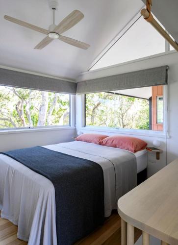 a bedroom with a large bed and a window at Crane Lodge in Palm Beach