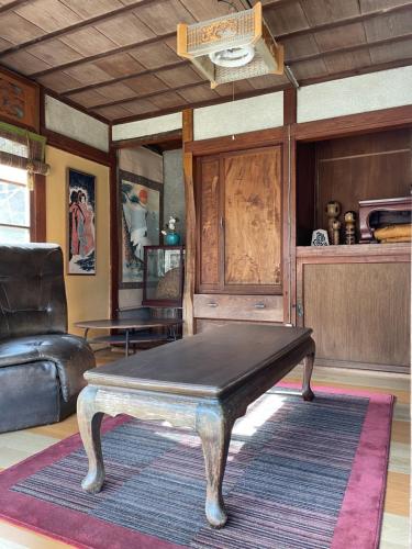 a coffee table in a living room with a couch at Konosu Onsen 鴻の巣温泉 1F in Sendai