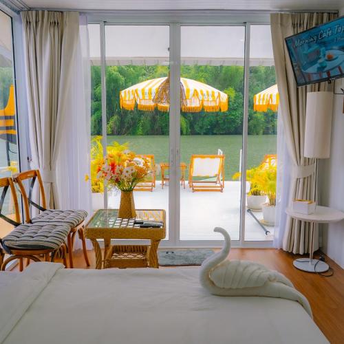 a bedroom with a bed and a view of a patio at Erawan Mountain Beach & Maya Erawan & Goodview Erawan in Tha Kradan
