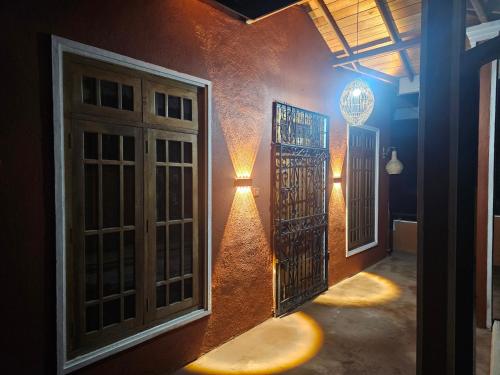 a room with doors and a light on the wall at Bloomy villa in Hatton