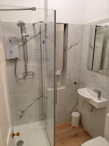 a bathroom with a shower and a sink at Lantern Guest House in Edinburgh