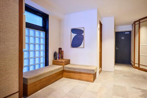 a hallway with a bench and a window at Hotel Vintage Tokyo Kagurazaka in Tokyo