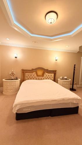 a bedroom with a bed and two night stands at Luxury Private house in Richmond