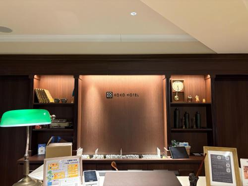 an office with a desk with a clock on the wall at KOKO HOTEL Ikebukuro in Tokyo