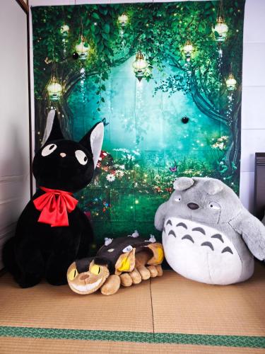 two stuffed animals sitting on the floor in front of a wall at Kyoto151 in Kyoto