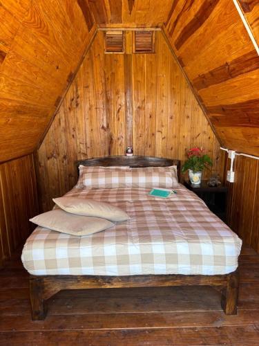 a bedroom with a bed in a wooden cabin at Mountain springs resort in Ban Nong Khieo