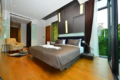 A bed or beds in a room at Bukit Pool Villas - SHA Extra Plus