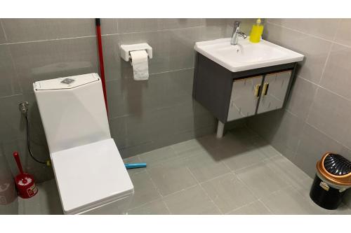 a bathroom with a sink and a toilet and a sink at OYO 1202 Shilla Hotel in Pampang
