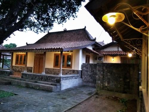 a small house with a tile roof at Omah Pitoe Yogya Homestay in Yogyakarta