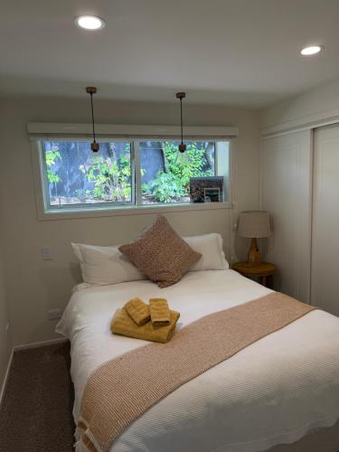 a bedroom with a bed with two towels on it at Villa @23 in Wanaka