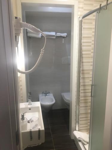 a small bathroom with a sink and a toilet at La Maison in Manfredonia