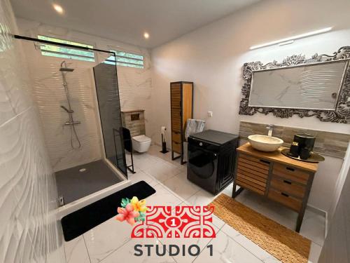 a bathroom with a shower and a sink at Kahaia stay lodge in Papeete