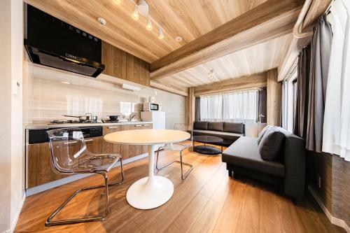 a kitchen and living room with a table and a couch at Matcha Inn Sakura Tokyo in Tokyo