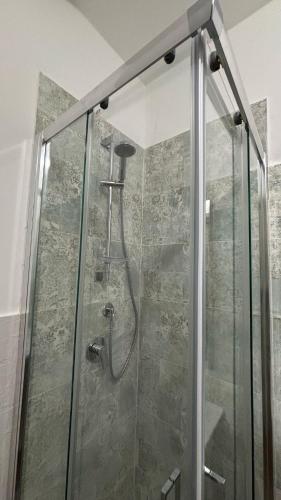 a shower with a glass door in a bathroom at Dimora Filangeri in Santa Flavia