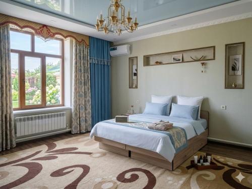 a bedroom with a bed and a large window at Kurak Homestay in Bishkek