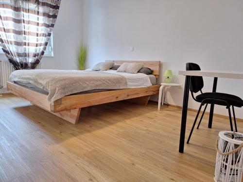 a bedroom with a bed and a table and a chair at Apartma San Izola - near the beach San Simon in Izola